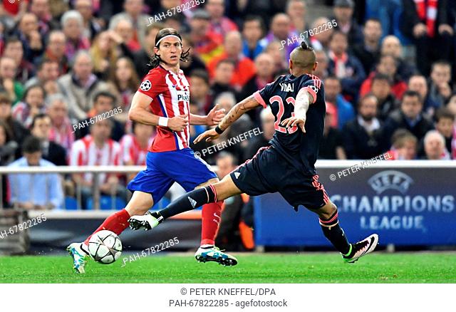 Munich's Arturo Vidal (R) and Madrid's Filipe Luis vie for the ball during the Champions League semi-final match between Atletico Madrid and Bayern Munich in...