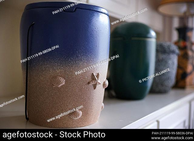 PRODUCTION - 11 November 2021, Schleswig-Holstein, Hamburg: Special urns for burials at sea made of unfired clay stand in the office of Germany's oldest sea...