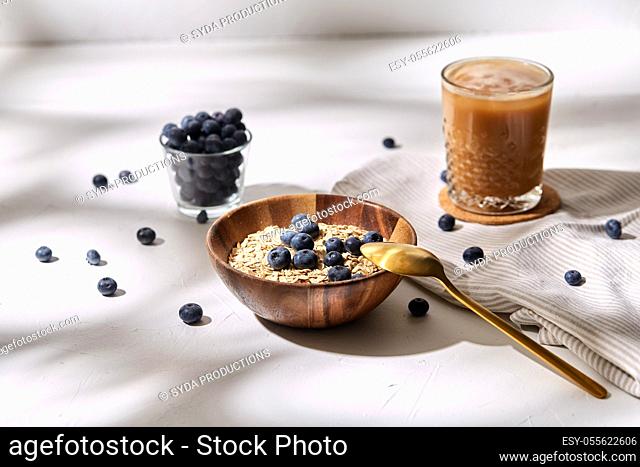 oatmeal with blueberries, spoon and coffee