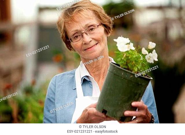 Senior Woman Holding Potted Plant