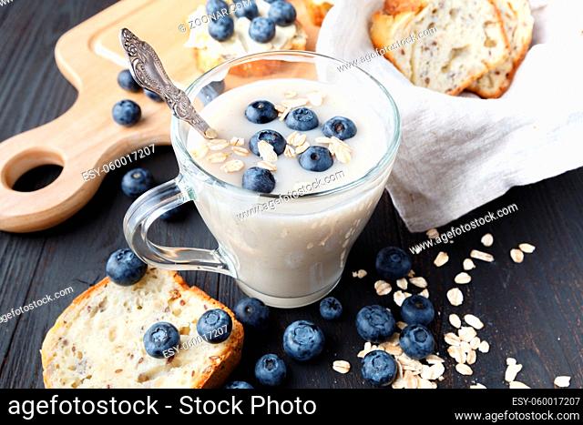 homemade healthy oat smoothie with berries on rustic wooden background