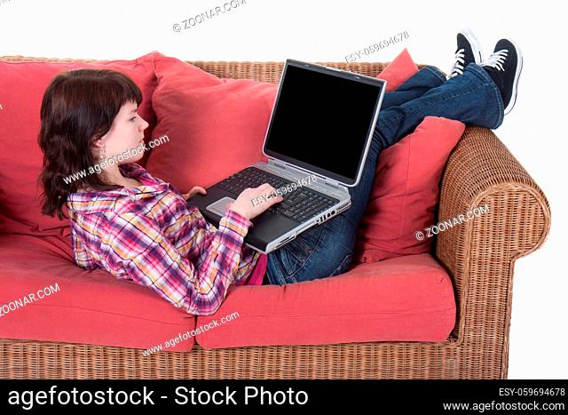 Young girl working on her laptop isolated on white