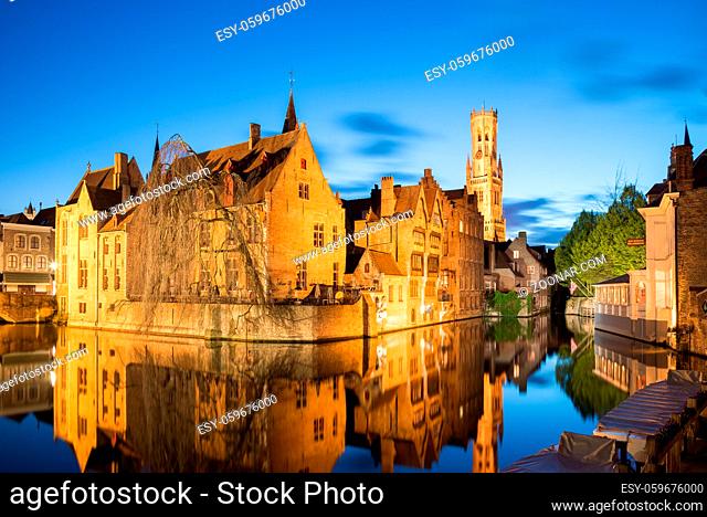 Bruges, Belgium - April 17, 2017: Night shot of historic medieval buildings along a canal in Bruges, Belgium