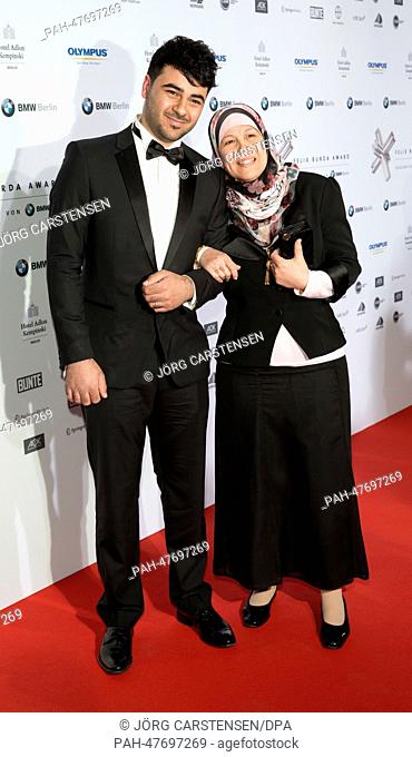 Ahmed Sarhan (L) and Waffa Warda arrive for the Felix Burda Award 2014 ceremony at Hotel Adlon in Berlin, Germany, 6 April 2014