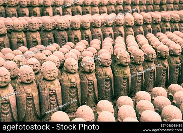 rows of many similar sculptures of Jizo deities in Kamakura, Japan