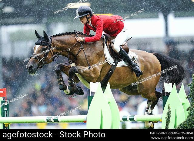 30 June 2022, North Rhine-Westphalia, Aachen: Equestrian sport, show jumping, CHIO, Nations Cup: German show jumper Jana Wargers on the horse Limbridge jumps...