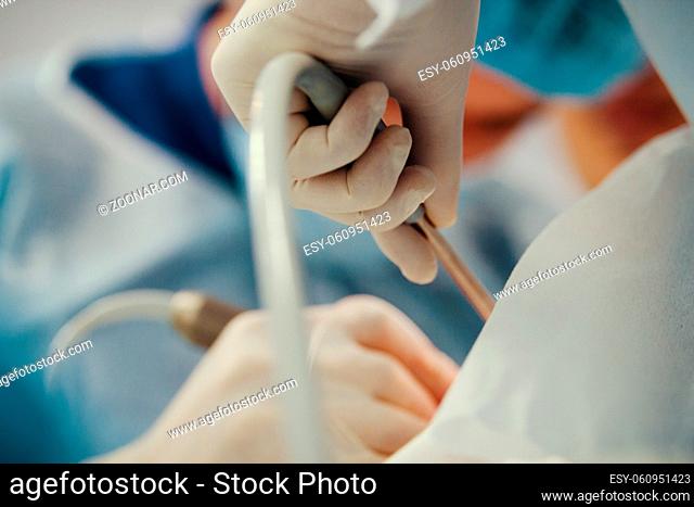 Surgeons in surgery room makes medical operation for patient, close up