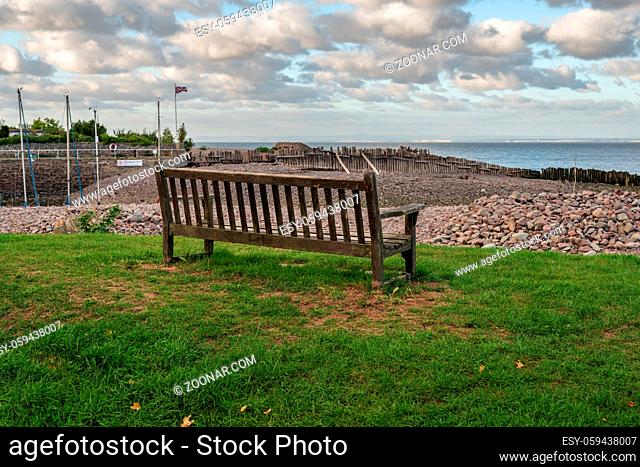 A bench on the beach in Porlock Weir, Somerset, England, UK - looking at the Bristol channel