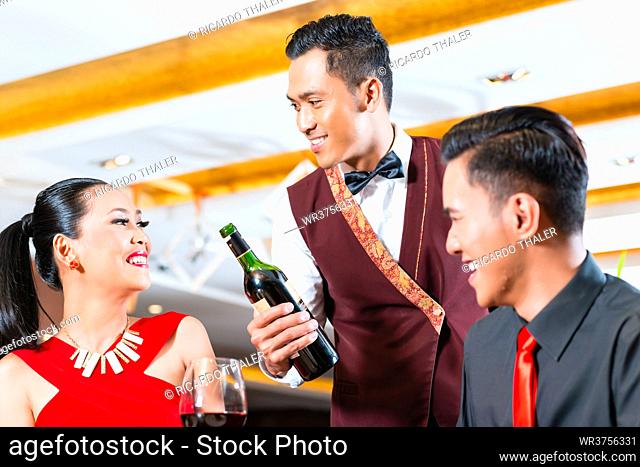 Asian Couple laughing in restaurant