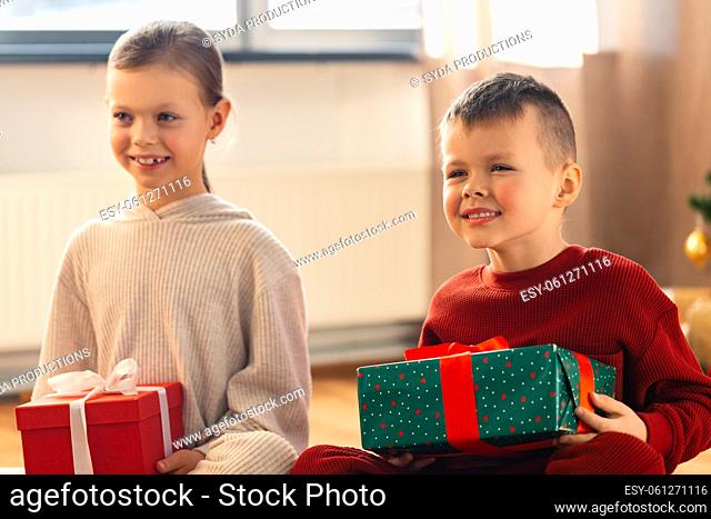 happy children with christmas gifts at home