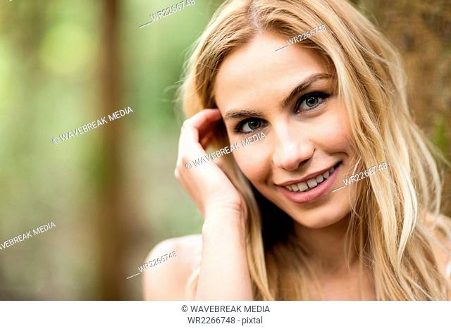 Close up of beautiful blonde woman in the woods