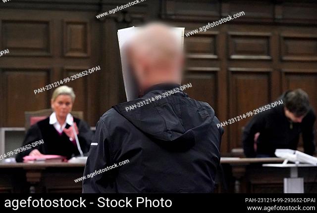 14 December 2023, Hamburg: The defendant stands in the courtroom in the criminal justice building at the start of the trial for attempted murder