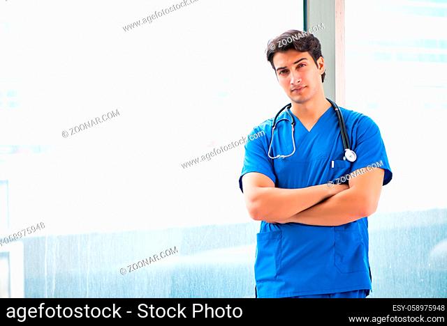 Young handsome doctor working in the hospital