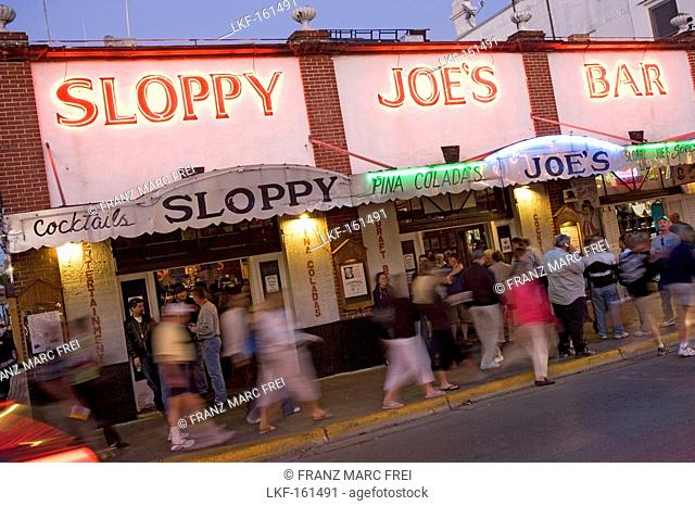 People standing in front of Sloopy Joes Bar in the evening, Duval Street, Key West, Florida Keys, Florida, USA