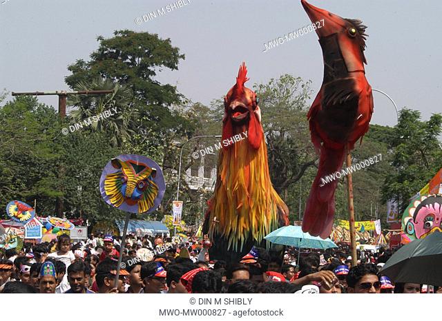People having colourful display in their hands taking part in a procession called Mangal Sobha Yatra on the occassion of Bangla new year