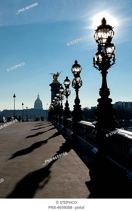 Lanterns of Alexandre III bridge, illuminated by sun rays, 7eme arrondissement, Paris, France