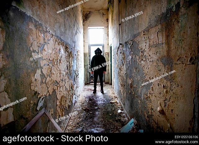 Post apocalyptic survivor in gas mask in a ruined building. Environmental disaster, armageddon concept