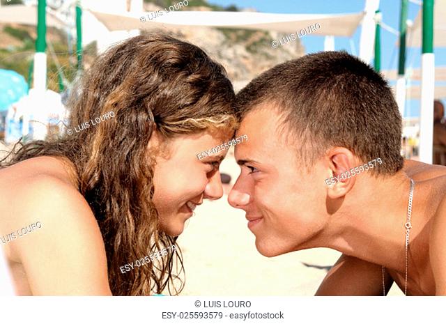 Young teenagres couple together in the beach