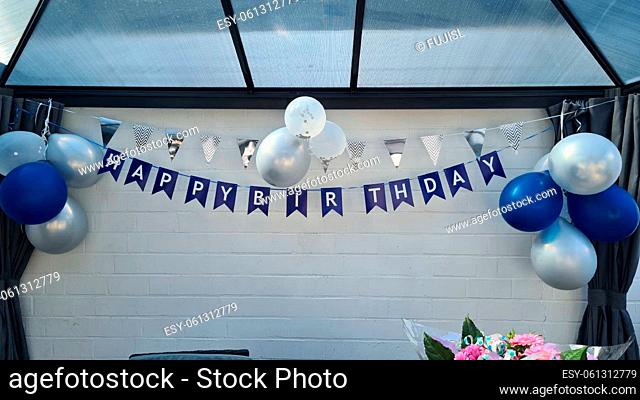 Celebration banner. Happy birthday party background with golden ribbons, confetti and balloons. Realistic anniversary