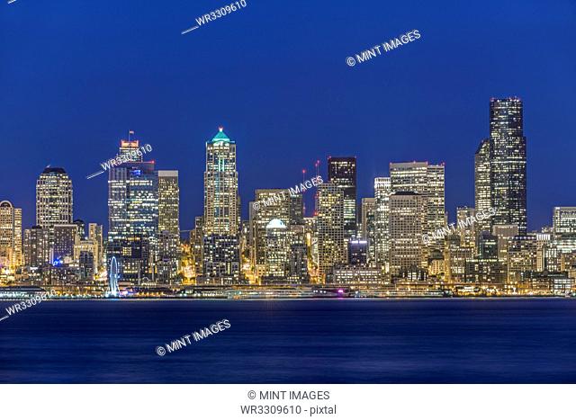 City skyline lit up at night, Seattle, Washington, United States