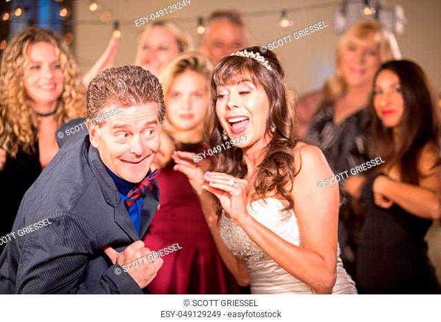Bride and Man Doing Chicken Dance at a Wedding