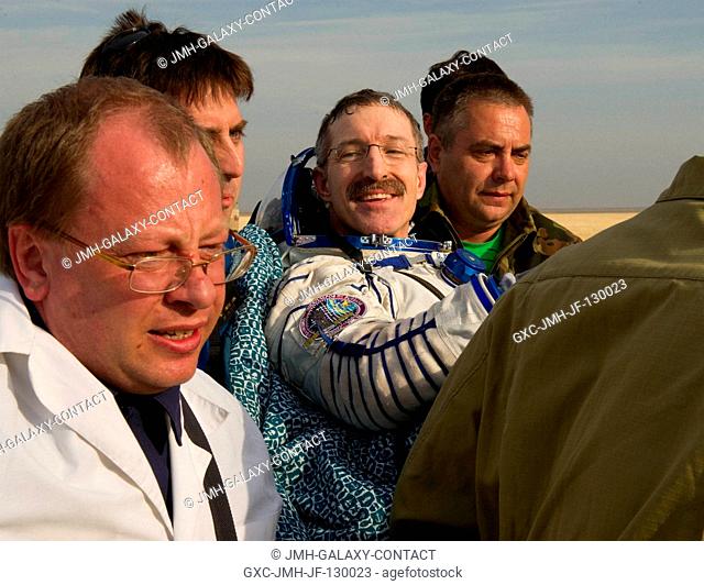 Expedition 30 Commander Dan Burbank is carried in a chair to the medical tent after he and Expedition 30 Flight Engineers Anton Shkaplerov and Anatoly Ivanishin...