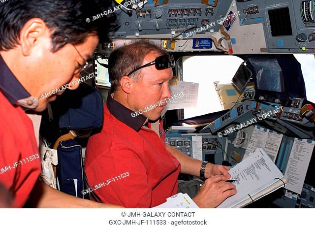 NASA astronaut Dominic Gorie (right), STS-123 commander, and Japan Aerospace Exploration Agency (JAXA) astronaut Takao Doi, mission specialist