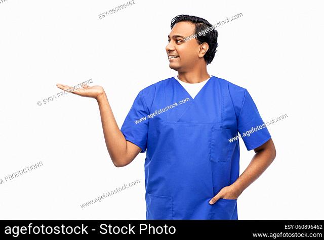 indian male doctor holding something on hand