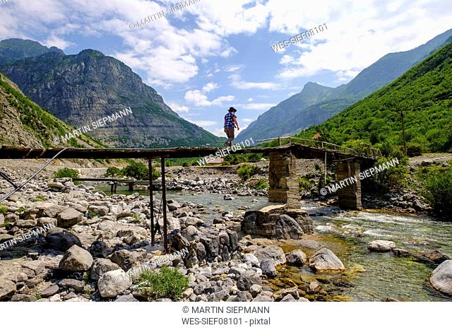Albania, Shkoder County, Albanian Alps, Cem Canyon, hiker on bridge over Cem river