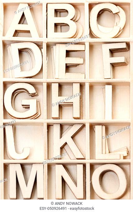 In a collection box ordered plywood letters A to O with mirrored letter J in plan view