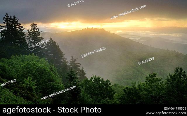 View of the Smokie Mountains from Blue Ridge Parkway with dramatic evening skies and fog rising from the valleys