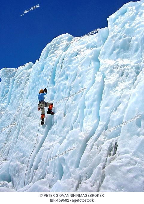 Female climber with crampons on a rope in lower Khumbu Icefall, Base Camp, 5300m, Mount Everest, Himalaya, Nepal