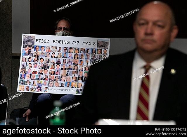 Michael Stumo holds a sign displaying photographs of the individuals who were killed in the March 10, 2019, crash of Ethiopian Airlines flight 302