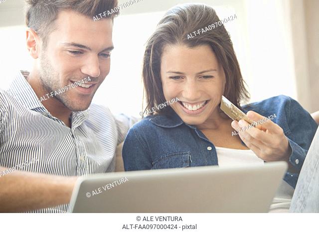 Couple at home shopping online together