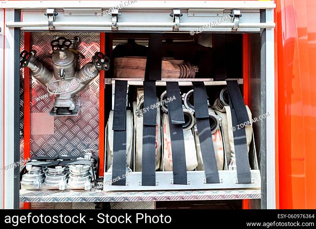 fire hoses, valves, adapters contained in the box of a fire truck