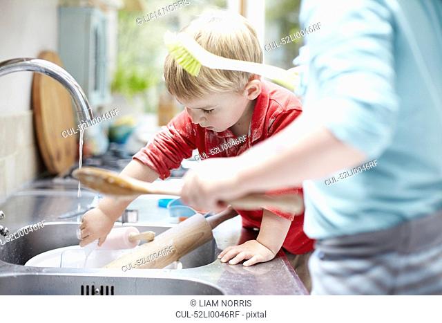 Children washing dishes together