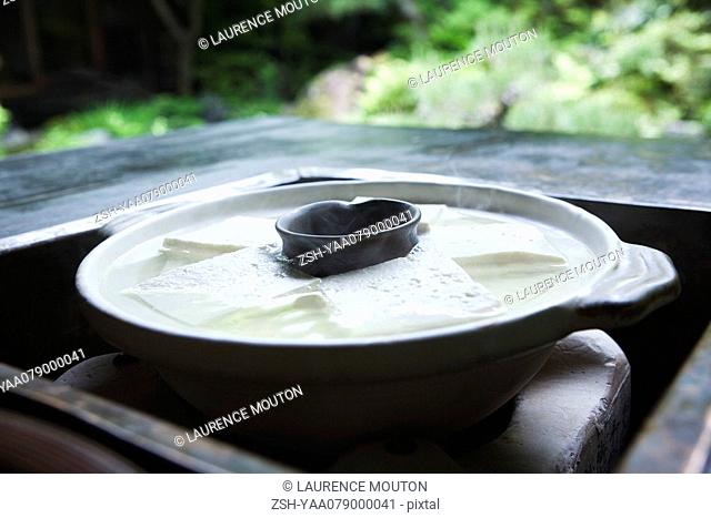 Yudofu in ceramic pot cooking in Japanese brazier