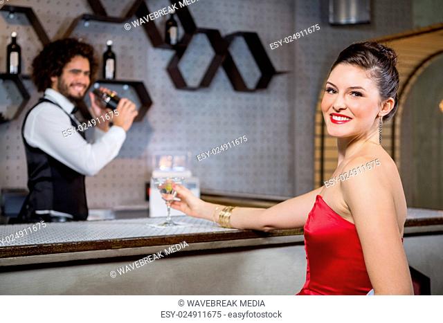 Portrait of beautiful woman standing at bar counter