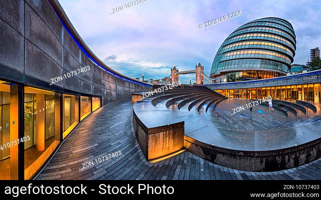 LONDON, UNITED KINGDOM - OCTOBER 7, 2014: London City Hall and Tower Bridge in London, UK. The City Hall has an unusual, bulbous shape