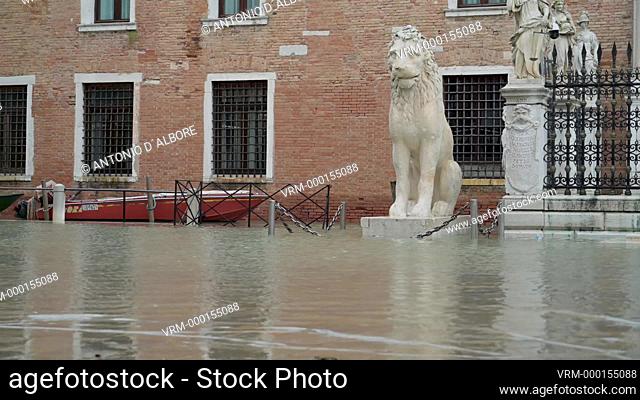 Naval army cadets walking trough the so called ""acqua alta"" high tide nearby the Arsenale. Venezia. Italy