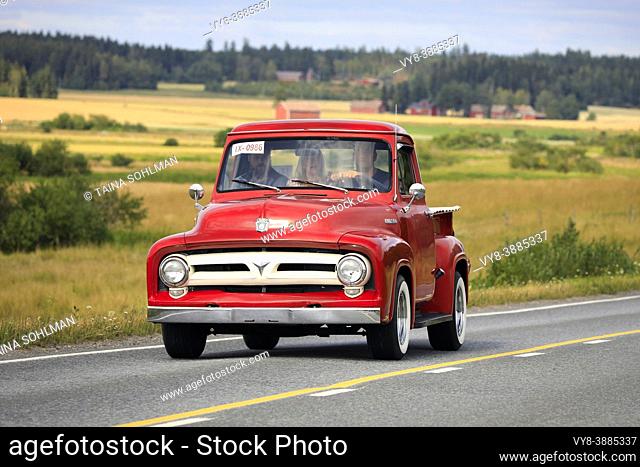 Driving red Ford F100 pickup truck, early to mid 1950s, Maisemaruise 2019 car cruise. Vaulammi, Finland. August 3, 2019