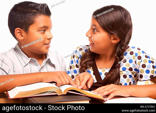 Hispanic brother and sister having fun studying together isolated on a white background