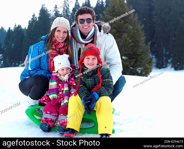 Winter playing, fun, snow and family portrait sledding at winter time