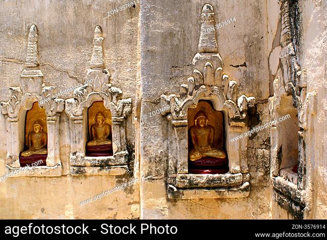 Golden Buddhas on the wall of termple in Bagan, Myanmar