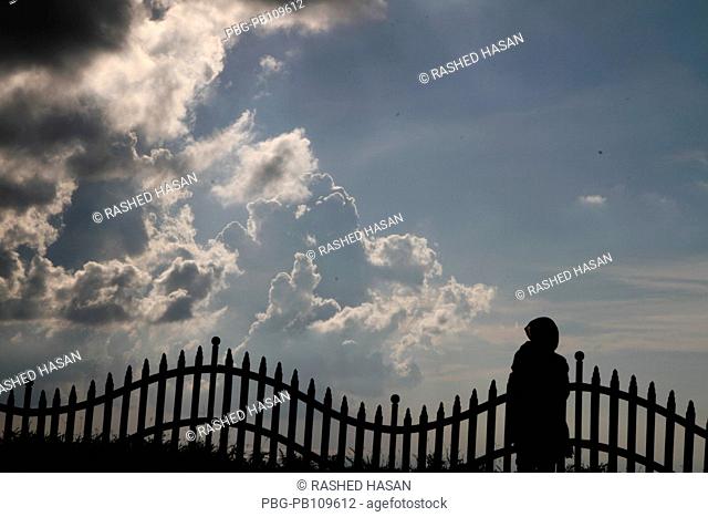 A girl stands beside a fence at the Nilgiri Hill which is located 47 kilometers Southeast of Bandarban town on Chimbuk range