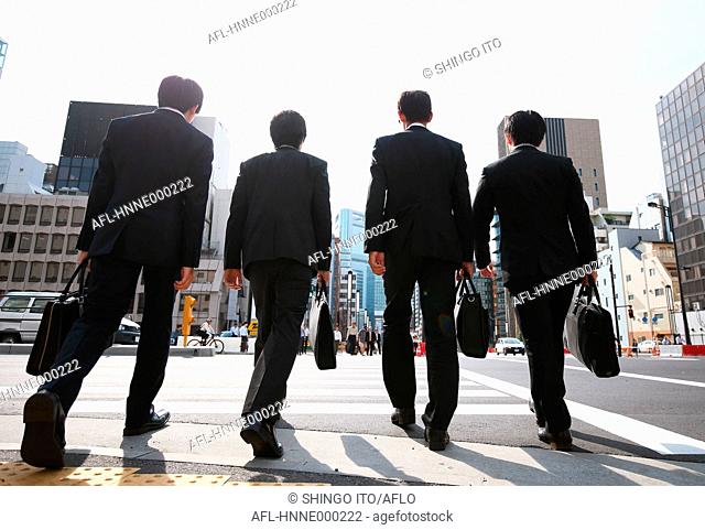 Young Japanese businessmen walking