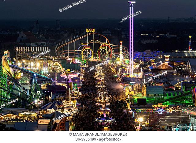 Rides on the fairground road with Olympia Looping, Fünferlooping roller coaster at night, Oktoberfest, Theresienwiese, Munich, Upper Bavaria, Bavaria, Germany