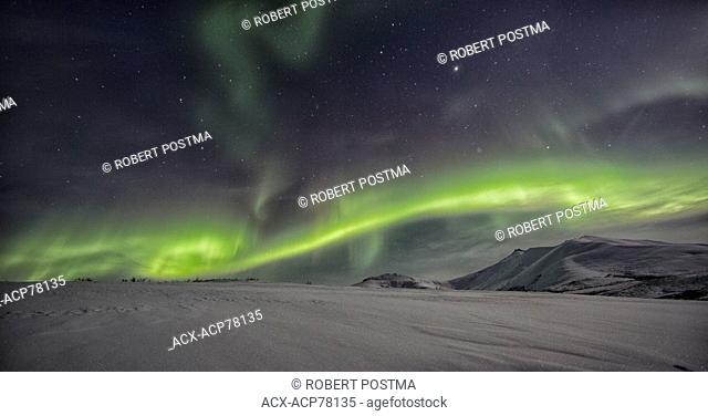 Northern lights or aurora borealis above the snow covered tundra along the Dempster Highway, Yukon
