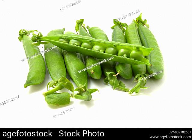Sweet pea pods. Young peas isolated on white background. Fresh and healthy vegetables