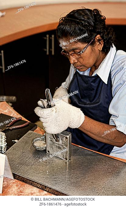Worker pouring hot fluid in molds in Pewter Factory called Royal Selangor in Kuala Lumpur Malaysia Asia